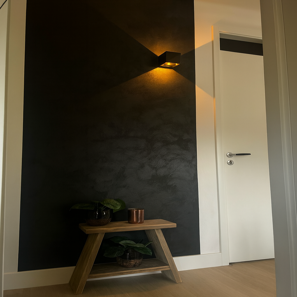 Modern interior with a dark wall, wooden shelf, and light fixture.