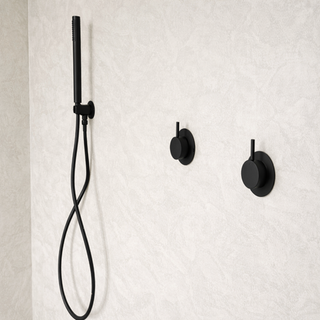 Black shower head and fixtures mounted on a textured white wall.