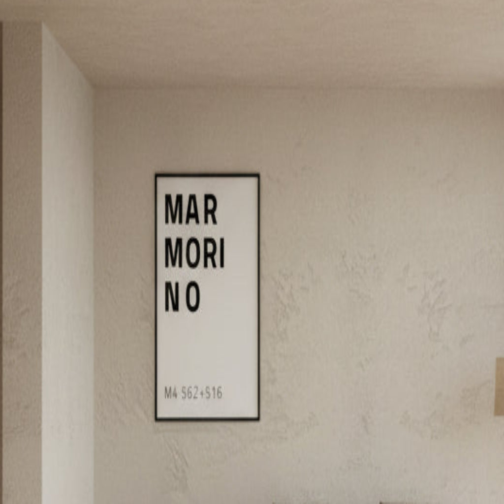 Modern living room with neutral tones, a sofa, and a framed picture on the wall.